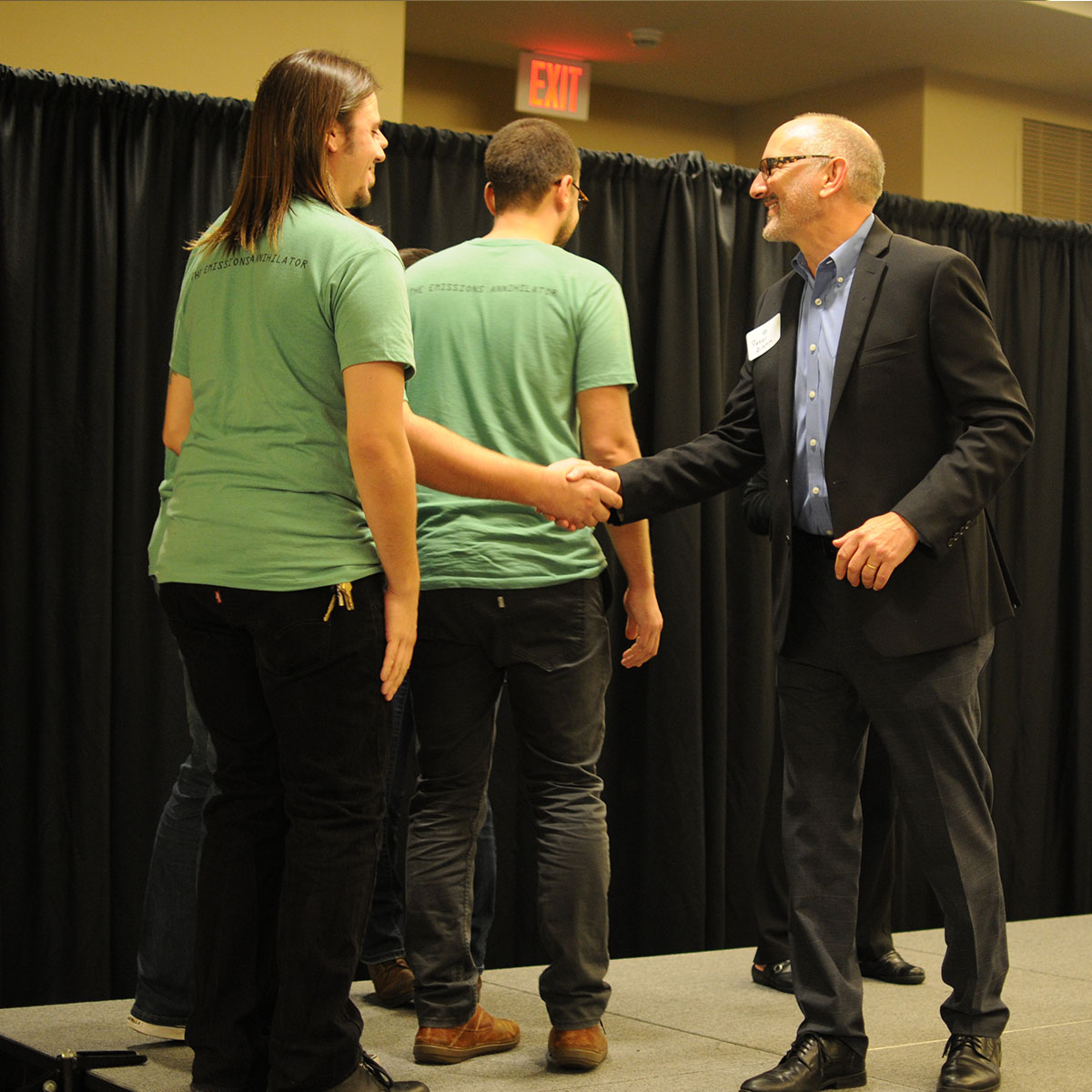 Recyclinator Team on stage shaking hands with Peter Zahn